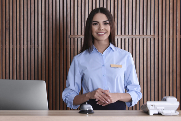 Portrait of receptionist at desk in lobby